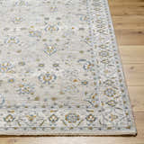 Close-up of Amaru Cream & Sage Textured Rug. Features a traditional floral pattern in sage, cream, and mustard tones. Front