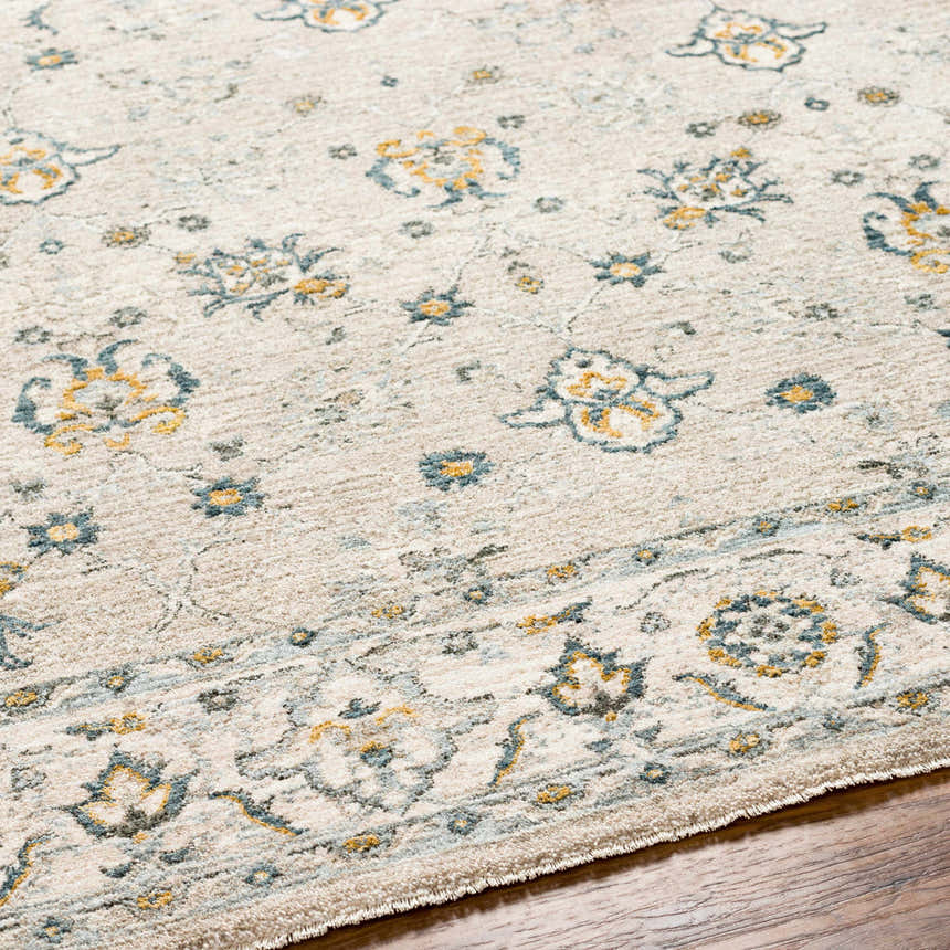 Close-up of the Amaru Cream & Sage Textured Rug with Fringes, showing floral pattern and soft, neutral colors. Texture