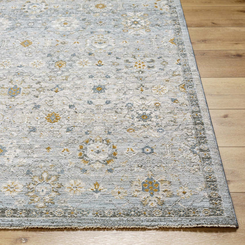 Close-up of the Annie Green Textured Rug with Fringes, featuring a traditional floral pattern in soft blue, gold, and white tones. Front