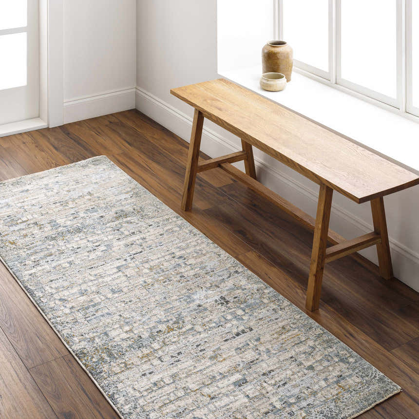 Entryway with wood bench and Chaka Textured Rug in light gray, blue, and mustard on a dark wood floor. Roomscene-Runner