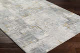 Close-up of the Elina Textured Abstract Rug. Features dusty sage, ink blue, and mustard hues in a contemporary design. Corner