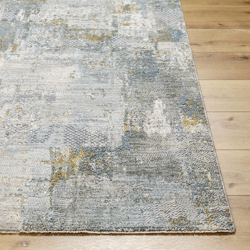 Close-up of the Elina Textured Abstract Rug. Features dusty sage, ink blue, light gray, and mustard hues. Front