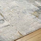 Close-up of the Elina Textured Abstract Rug. Off-white, light gray, and mustard hues create a contemporary design. Texture