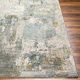 Close-up of Elina Textured Abstract Rug showing dusty sage, ink blue, mustard, and gray tones on wood floor. Front
