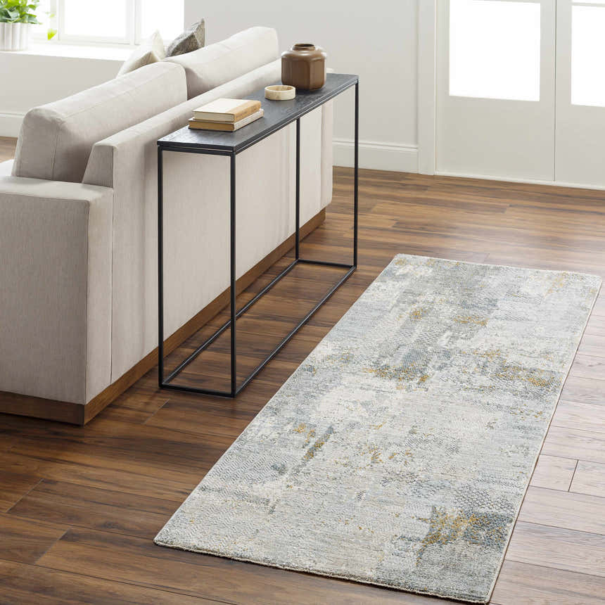 Living room scene with Elina Textured Abstract Rug in dusty sage, blue, and gray. Modern sofa and console table. Roomscene-Runner