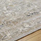 Close-up of the Gioia Area Rug. Beige and bone colors with a traditional, distressed pattern and subtle texture. Texture