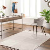Bright home office with wood desk, gray chair, and neutral Anaya Cream Area Rug with tassels. Roomscene-Rectangle