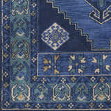 Close-up of the Selden Area Rug in shades of blue and teal with a geometric, floral-inspired pattern. Swatch