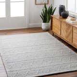 Entryway with the light gray Kyung Area Rug, wood floors, and a mid-century modern cabinet. Roomscene-Rectangle