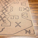 Close-up of the Hamid Washable Jutely Rug in camel, showing its geometric dark brown pattern and jute texture on wood floor. Front