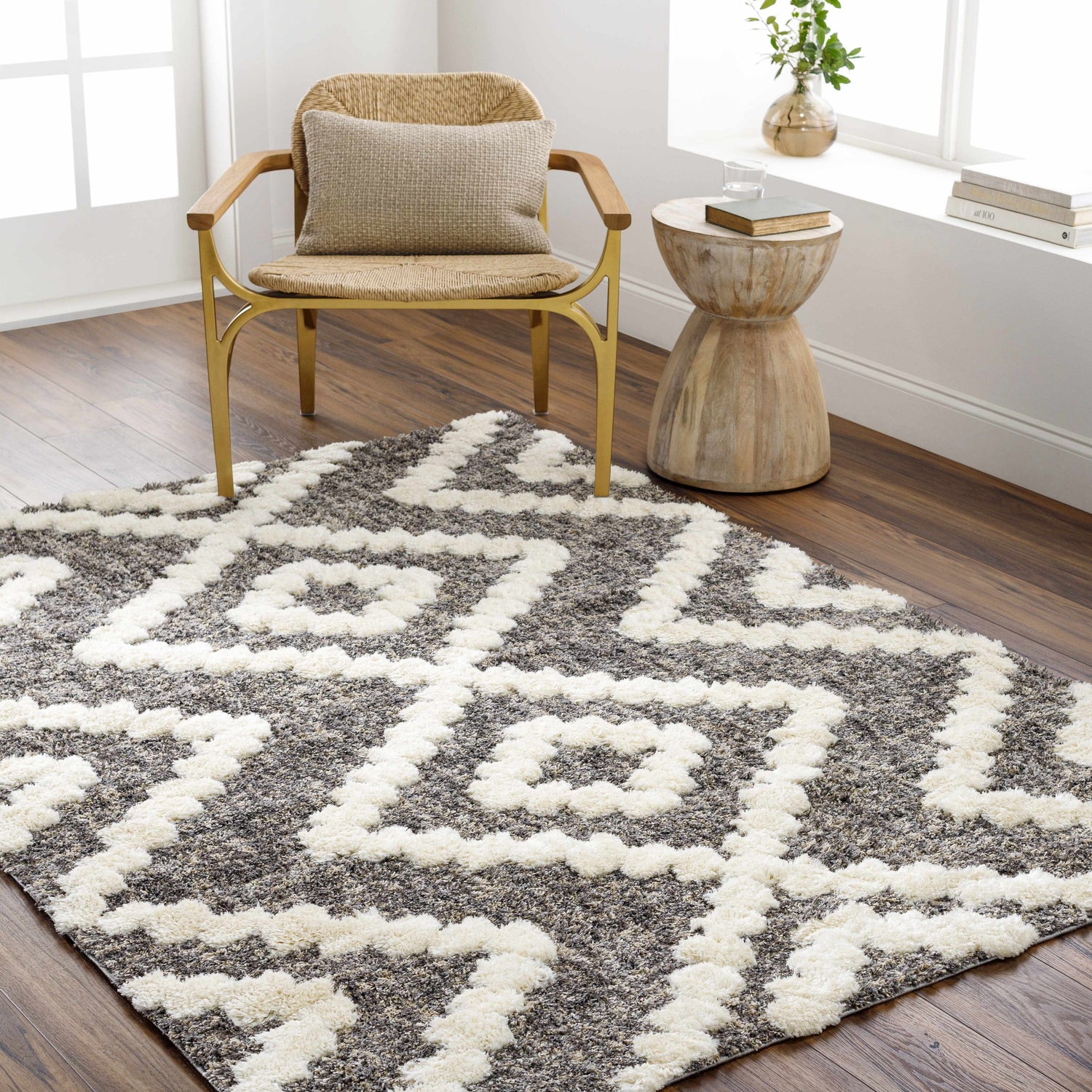 Farmhouse-style room with a Rian Brown Area Rug, woven chair, and wood side table on a dark wood floor. Roomscene-Rectangle