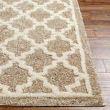 Close-up of the Yepa Tan Area Rug showing a geometric shag design in cream and tan on hardwood floors. Front