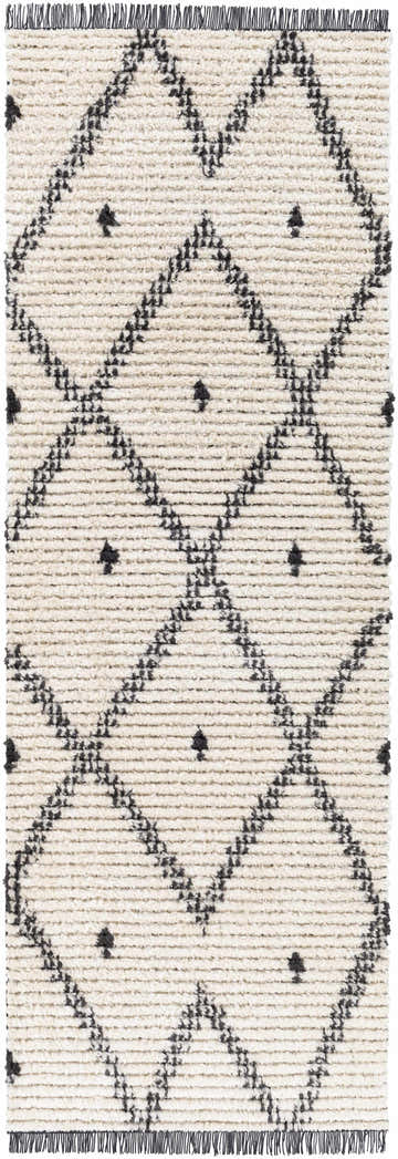 Close up of the Shae Area Rug, a cream rug with a black geometric diamond pattern and fringe. Design-Runner-2773