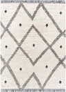 Close-up of the Shae Area Rug, a cream rug with a black geometric diamond pattern and fringe. Design-Rectangle-537