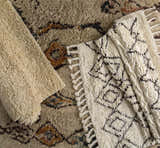 Close-up of Lothian Area Rug showing ivory shag texture, charcoal geometric pattern, and hand woven wool construction. Styleshot