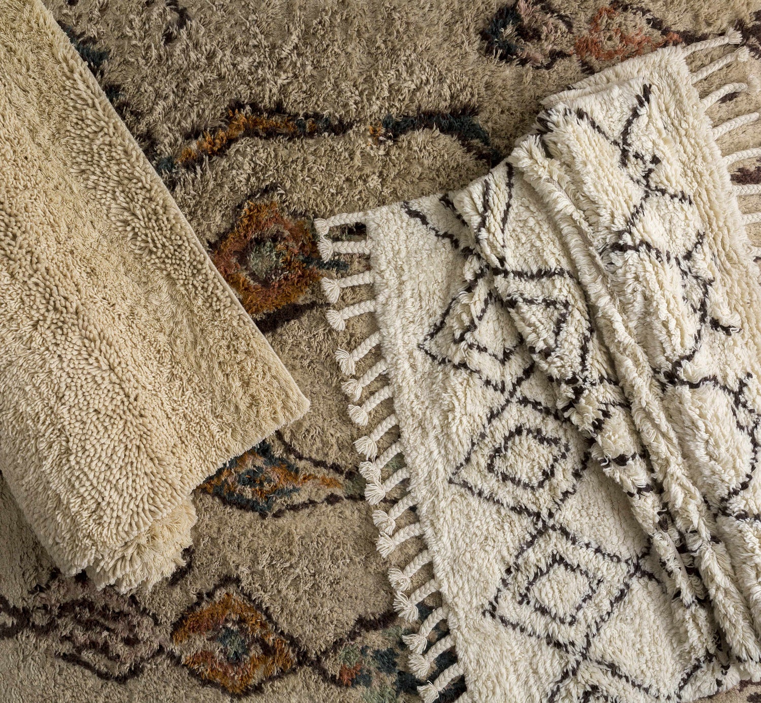 Close-up of Lothian Area Rug showing ivory shag texture, charcoal geometric pattern, and hand woven wool construction. Styleshot