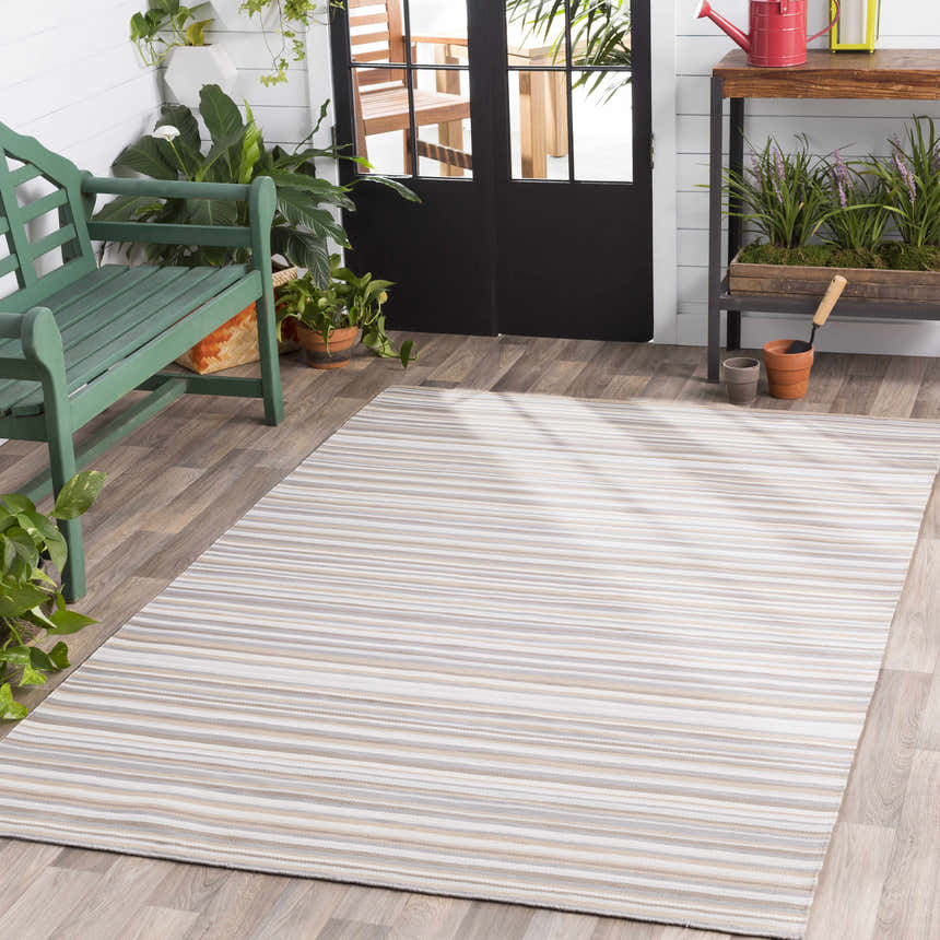 Sunroom scene with a striped Shawville Area Rug, green bench, plants, and potting table. Roomscene-Rectangle
