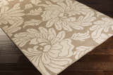 Close up of the beige Sherard Area Rug with a large floral pattern on dark wood flooring. Corner