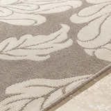 Close-up of the Sherard Area Rug, featuring a beige and dark red floral pattern and machine-woven texture. Texture
