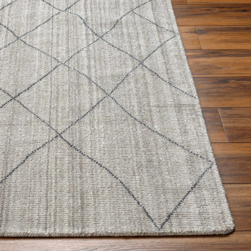 Close-up of the Nari Light Gray Area Rug showing its diamond pattern and textured weave on a dark wood floor. Front