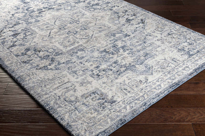 Close-up of the Shotts Thick Luxe Rug. Cream and denim blue oriental pattern on a soft, textured rug. Corner