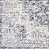 Close-up of the Shotts Thick Luxe Rug. Machine woven rug in cream, light gray, and dark blue with traditional oriental pattern. Swatch
