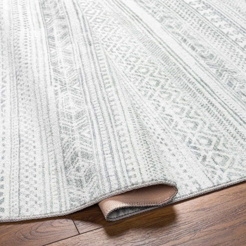 Close-up of the Gizeh Silverton Washable Area Rug showing its cloud gray, light gray, and silverton geometric pattern. Fold