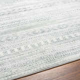 Close-up of the Gizeh Silverton Washable Area Rug showing its light gray, geometric, and striped pattern on wood floors. Texture