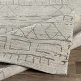 Close-up of Shortland Premium Area Rug with gray geometric pattern on ivory cotton and viscose blend. Fold