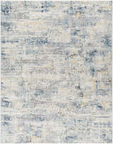 Close-up of the Hyman Area Rug showing its abstract pattern in camel, denim, and gray tones. Design-Rectangle-710103