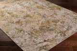 Close-up of the Aleka Rich Textured Rug in bone, clay, dark gray, and sage on a dark wood floor. Corner