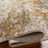 Close-up of the Aleka Rich Textured Rug in bone, clay, and gray, showing its woven texture and backing detail. Fold