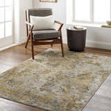 Living room scene with a gray chair on the Aleka Rich Textured Rug in bone, clay, dark gray, sage, and walnut tones. Roomscene-Rectangle