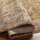 Close-up of the Ange Tan Rich Textured Traditional Rug, showcasing bone, clay, and walnut colors with a detailed pattern. Fold
