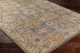Close-up of the Ange Cream & Blue Rich Textured Rug showing its bone, blue, and mocha traditional pattern. Corner