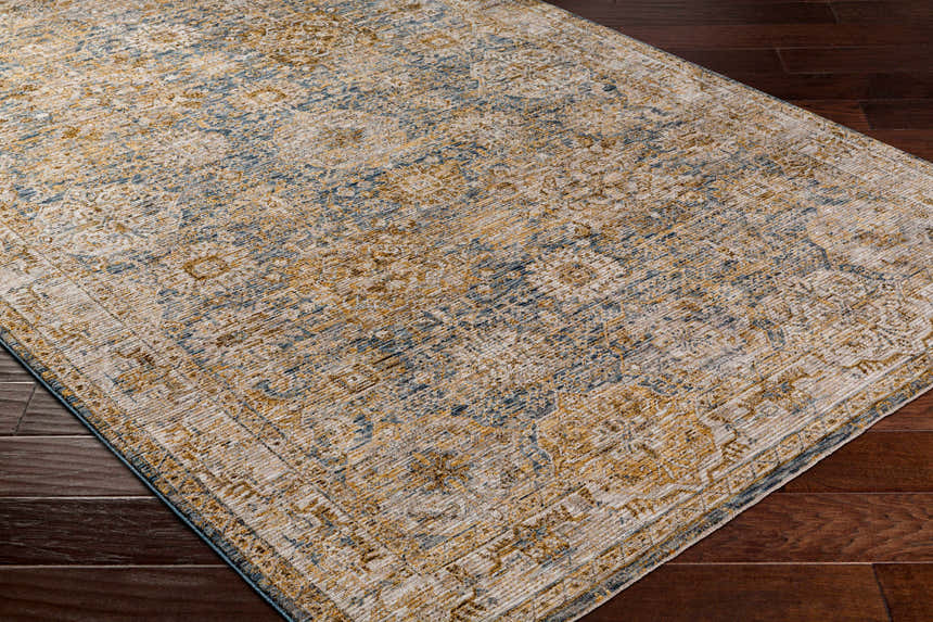 Close-up of the Ange Cream & Blue Rich Textured Rug showing its bone, blue, and mocha traditional pattern. Corner