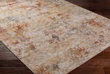 Close-up of the textured Chas Tan Rich Traditional Rug; bone, clay, and dark gray colors. Corner