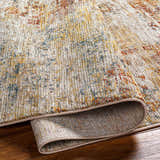 Close-up of the textured Chas Tan rug. Features bone, clay, dark gray, walnut, and white thatch colors. Fold