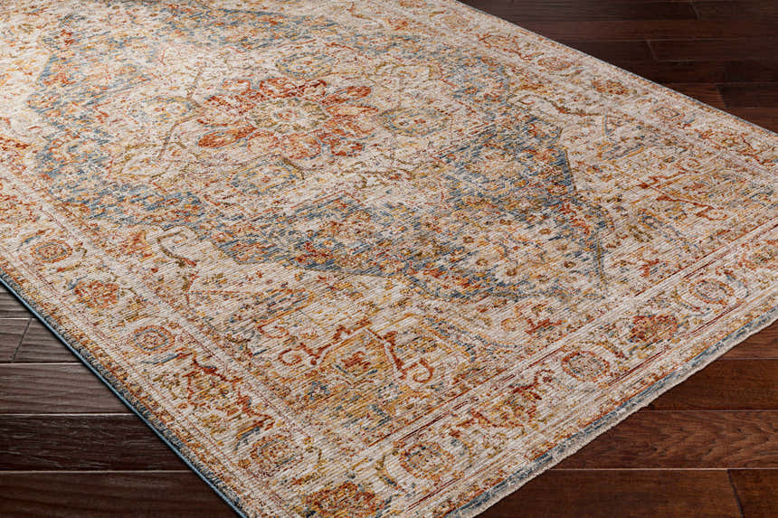 Close up of the Cress Tan Rich Textured Traditional Rug showing bone, blue, and rust colors. Corner