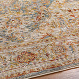 Close-up of the Cress Tan Rich Textured Traditional Rug showing bone, gold, blue, and red colors. Texture
