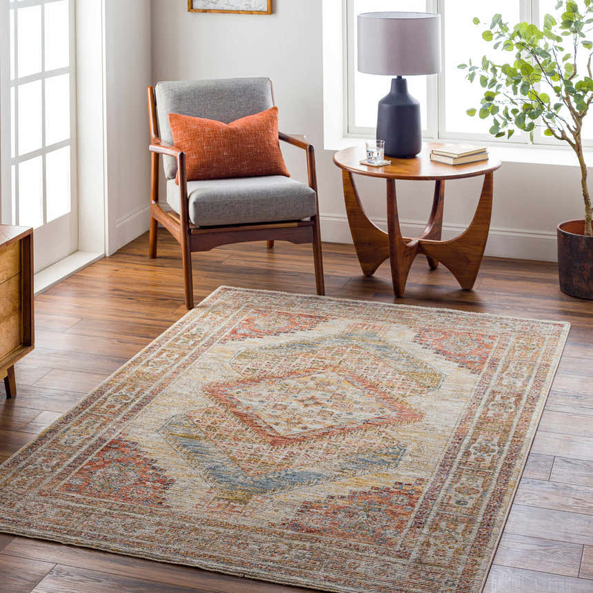 Living room scene with a Moya Tan Rich Textured Traditional Rug, gray chair, and wood accents. Roomscene-Rectangle