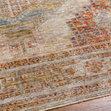 Close-up of the Moya Tan rug showing its rich texture, traditional pattern, and colors: bone, clay, brown, and gray. Texture