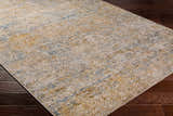 Close-up of Sava Tan Rich Textured Rug showing bone, dark brown, and blue abstract pattern. Corner