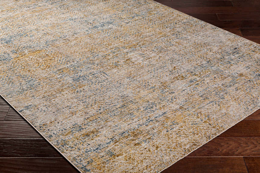 Close-up of Sava Tan Rich Textured Rug showing bone, dark brown, and blue abstract pattern. Corner