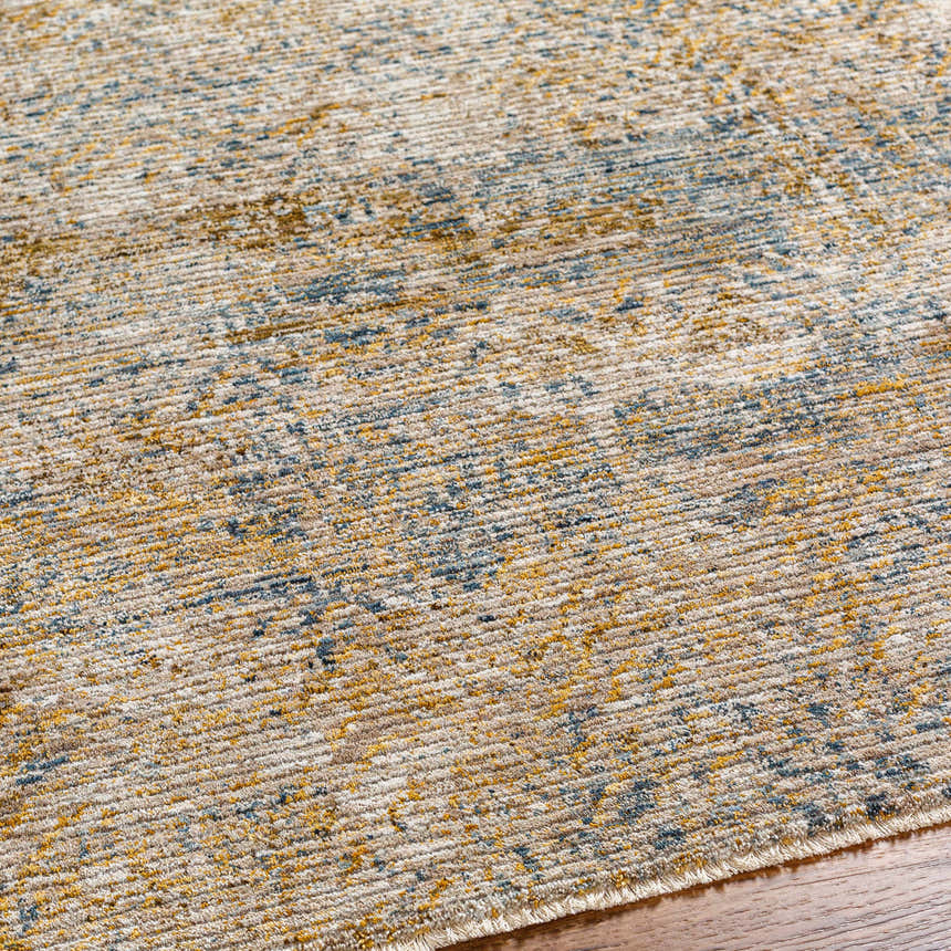 Close-up of the Sava Tan Rich Textured Rug, showing bone, brown, and blue tones with a subtle, contemporary pattern. Texture