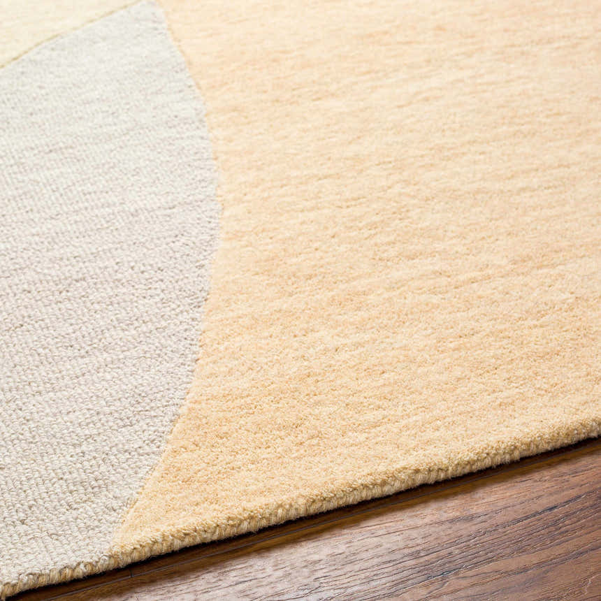 Close-up of the hand-tufted Cassiopeia Light Brown & Beige Area Rug showing wool texture and geometric design. Texture