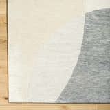 Close-up of Cassiopeia Gray & Beige Area Rug showing wool texture and contemporary ash, gray, and silver curved design. Corner