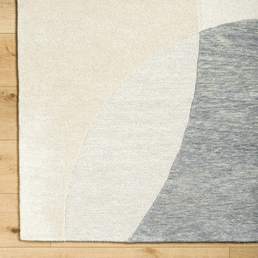 Close-up of Cassiopeia Gray & Beige Area Rug showing wool texture and contemporary ash, gray, and silver curved design. Corner