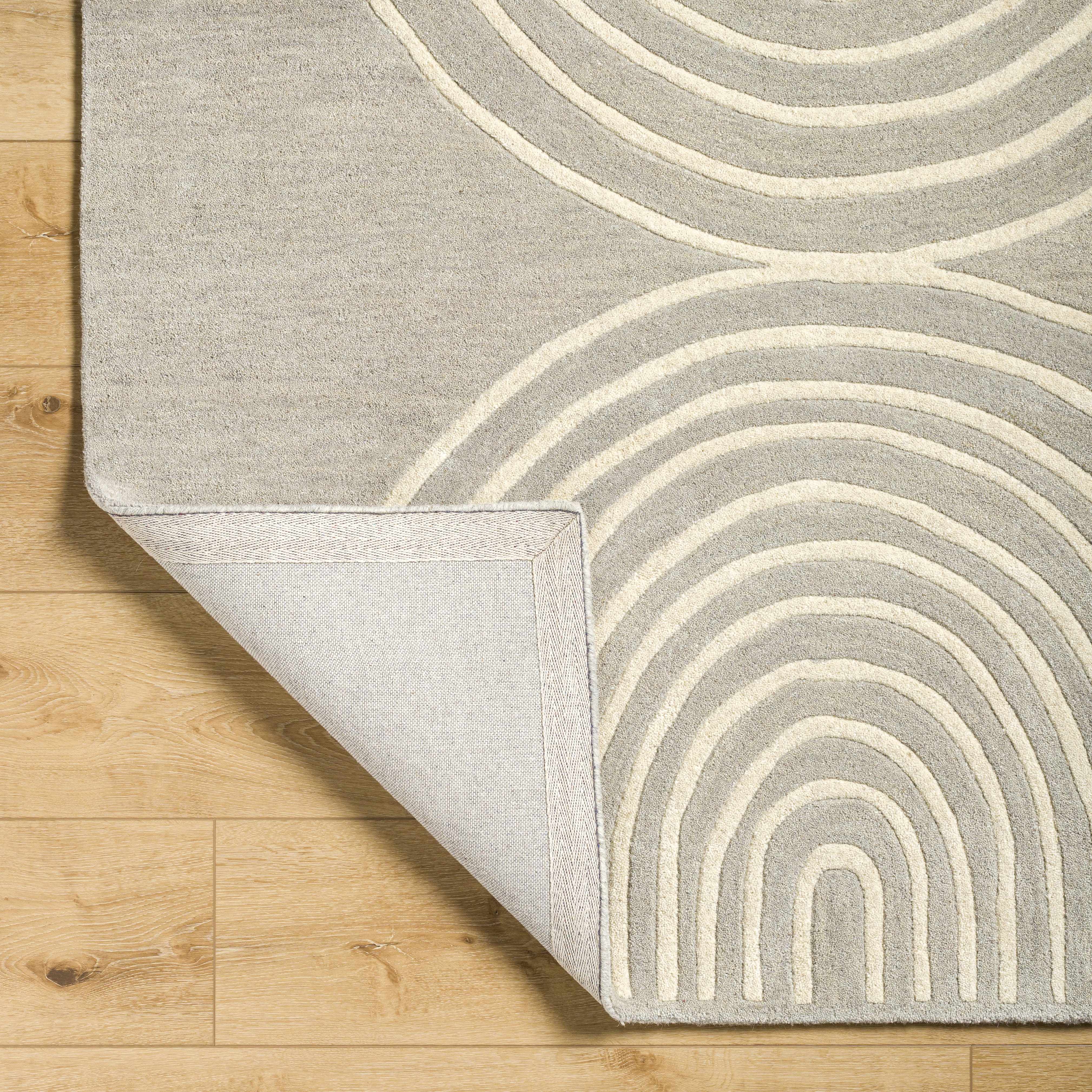 Folded section of Fuat Area Rug, displaying material thickness and weave. Contemporary Area Rug Backing Canvas 