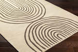 Close-up of the Fuat Beige Area Rug, a hand-tufted wool rug with a contemporary arch pattern in beige and dark brown. Corner